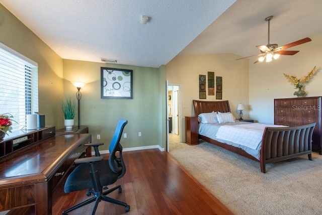 bedroom featuring a textured ceiling, visible vents, baseboards, vaulted ceiling, and dark wood-style floors