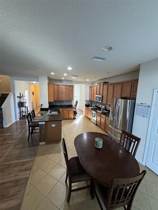 dining room featuring stairs, light tile patterned flooring, visible vents, and recessed lighting