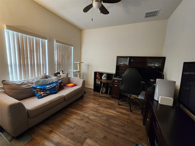 office space featuring a ceiling fan, visible vents, and wood finished floors