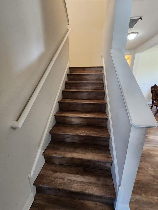 staircase featuring wood finished floors