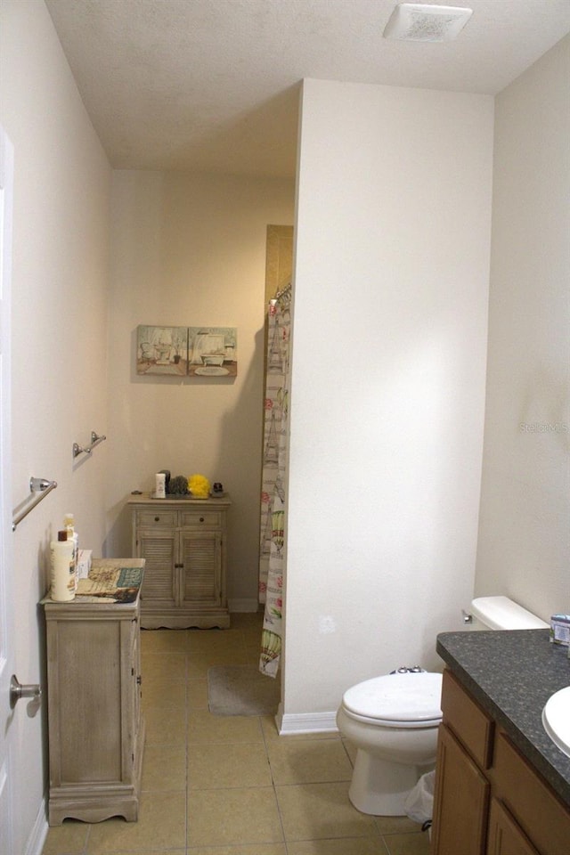 bathroom featuring visible vents, a shower with shower curtain, toilet, vanity, and tile patterned flooring