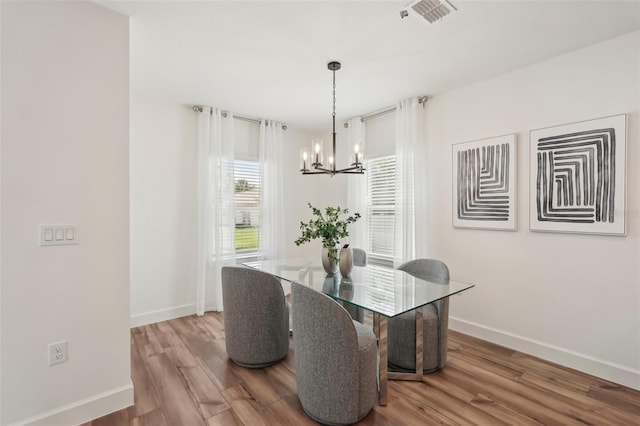 4754 Easter Ter, North Port, FL 34286 - dining room featuring a chandelier, visible vents, wood finished floors, and baseboards