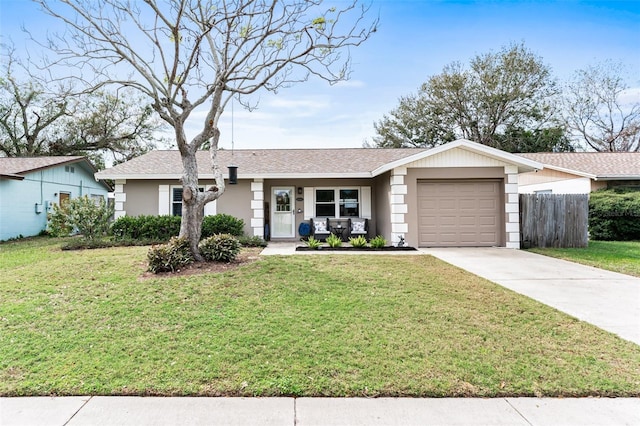 view of front of house featuring a garage, a front yard, concrete driveway, and fence