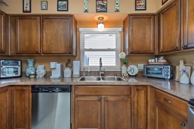 kitchen with brown cabinetry, a toaster, dishwasher, and a sink