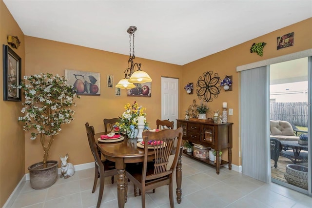 dining area with baseboards and light tile patterned floors