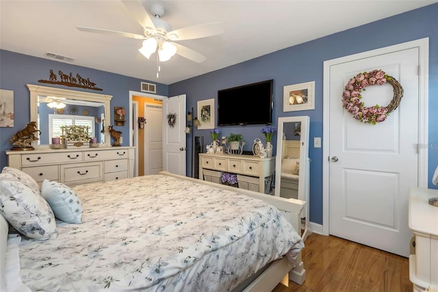 bedroom with ceiling fan, light wood-type flooring, and visible vents