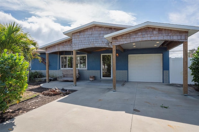 view of front facade featuring concrete driveway, an attached garage, and stucco siding