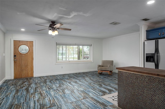 unfurnished room featuring baseboards, visible vents, and crown molding