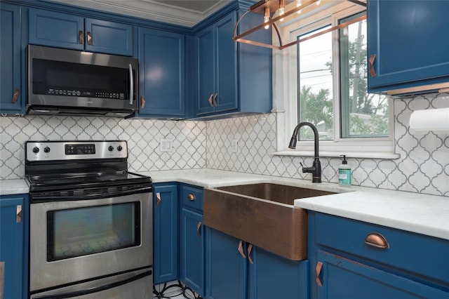 kitchen featuring stainless steel appliances, a sink, and blue cabinets