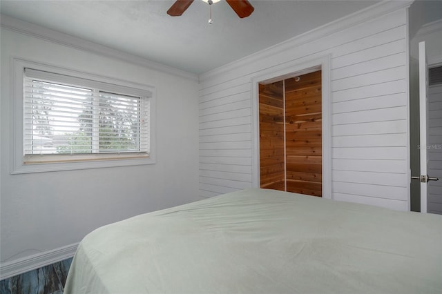 bedroom with ornamental molding, a ceiling fan, and baseboards