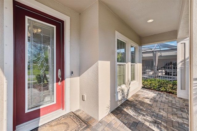 entrance to property featuring stucco siding