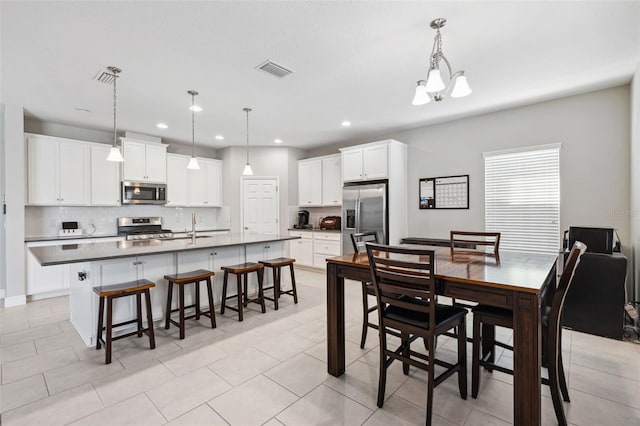 dining room with an inviting chandelier, visible vents, and recessed lighting