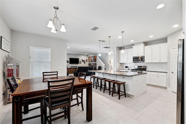 dining room featuring a chandelier, visible vents, and recessed lighting