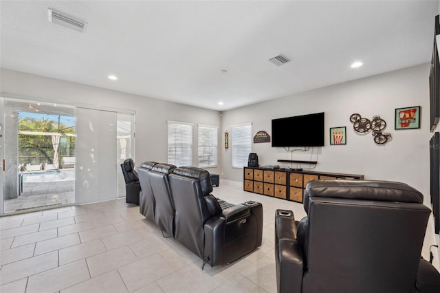 living room featuring visible vents, plenty of natural light, and light tile patterned flooring