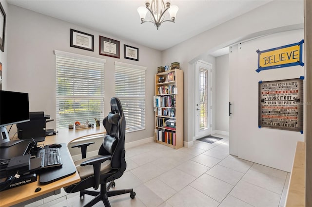 office featuring a chandelier, arched walkways, baseboards, and light tile patterned floors