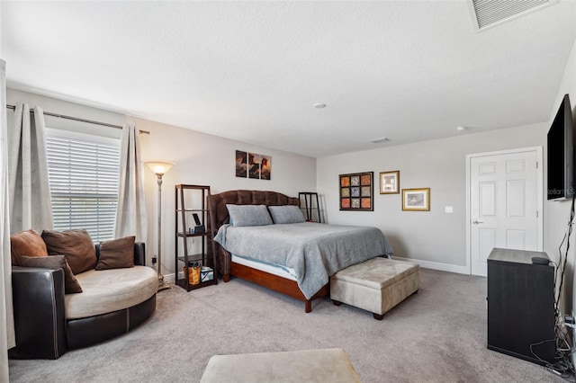 carpeted bedroom with baseboards, visible vents, and a textured ceiling