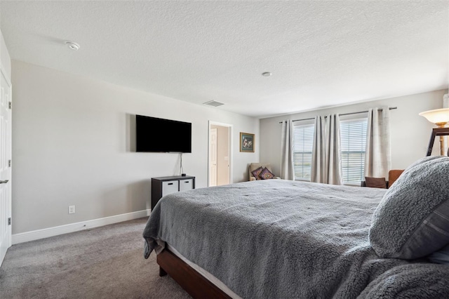 bedroom featuring a textured ceiling, carpet floors, visible vents, and baseboards