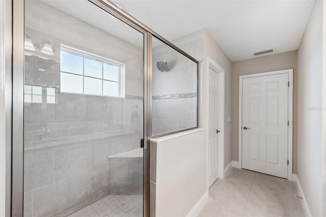 full bathroom with a stall shower, baseboards, visible vents, and tile patterned floors