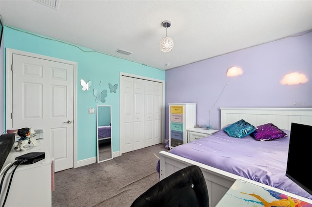 carpeted bedroom featuring a closet, visible vents, and baseboards