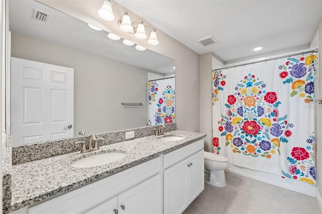 bathroom with toilet, visible vents, and a sink