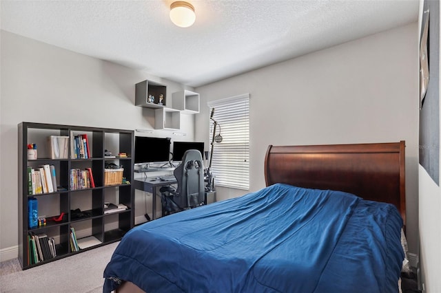 carpeted bedroom with baseboards and a textured ceiling