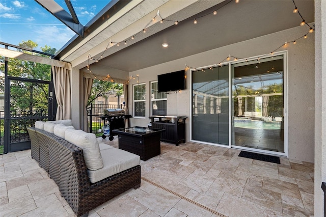 view of patio / terrace featuring a lanai, grilling area, and an outdoor hangout area