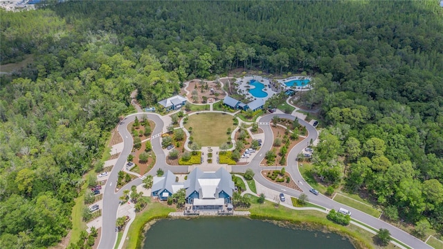 drone / aerial view featuring a water view and a view of trees