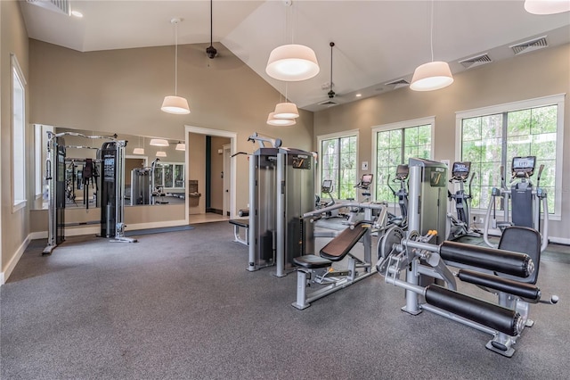 exercise room with high vaulted ceiling, ceiling fan, and visible vents