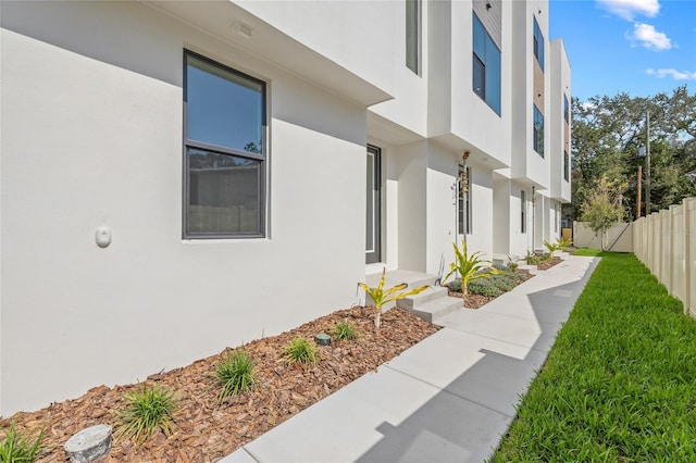 view of home's exterior featuring fence and stucco siding