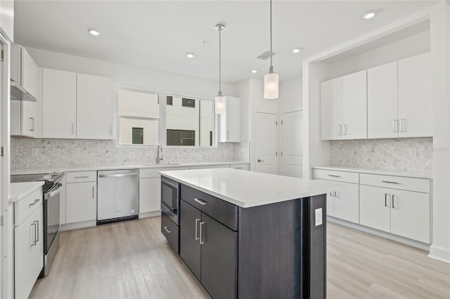 kitchen with range with electric cooktop, white cabinets, dishwasher, a kitchen island, and a sink