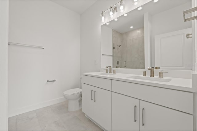 bathroom featuring baseboards, a sink, toilet, and a shower stall