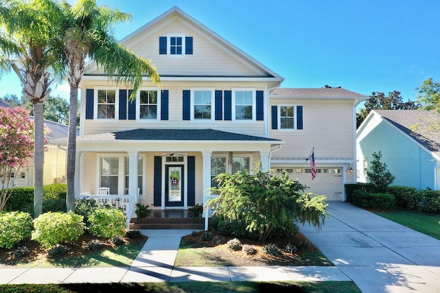 view of front of property featuring a garage, covered porch, and concrete driveway