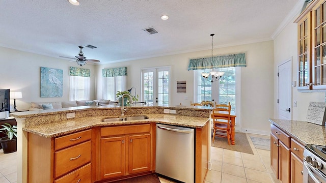 kitchen featuring visible vents, appliances with stainless steel finishes, open floor plan, a sink, and an island with sink