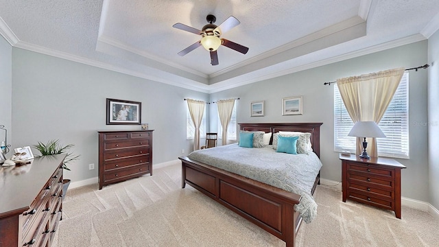 bedroom featuring a raised ceiling, light colored carpet, and multiple windows