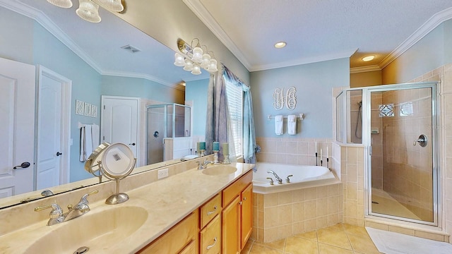 full bathroom featuring a sink, a shower stall, a bath, tile patterned floors, and crown molding