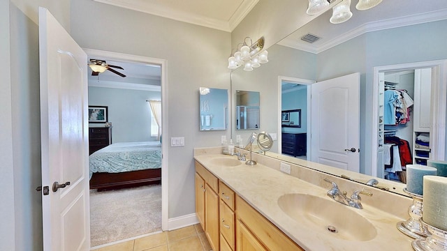 ensuite bathroom featuring crown molding, visible vents, connected bathroom, and a sink