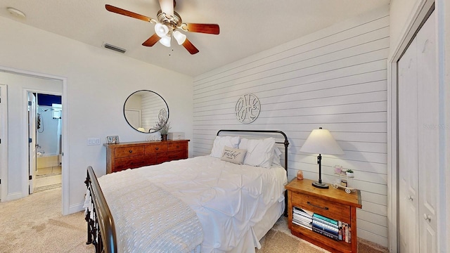 bedroom featuring light carpet, baseboards, visible vents, and a ceiling fan