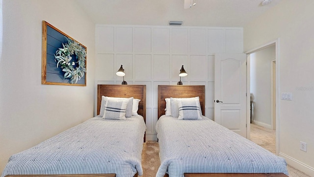 bedroom featuring light carpet, visible vents, and baseboards