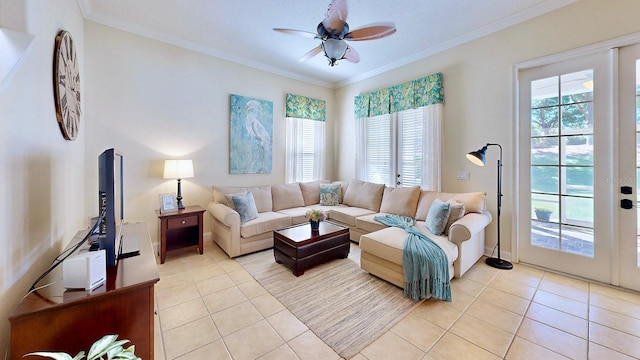 living room featuring ceiling fan, baseboards, crown molding, and light tile patterned flooring