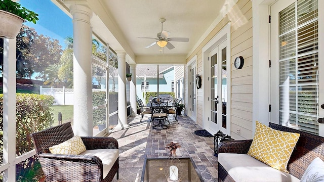 sunroom with ceiling fan