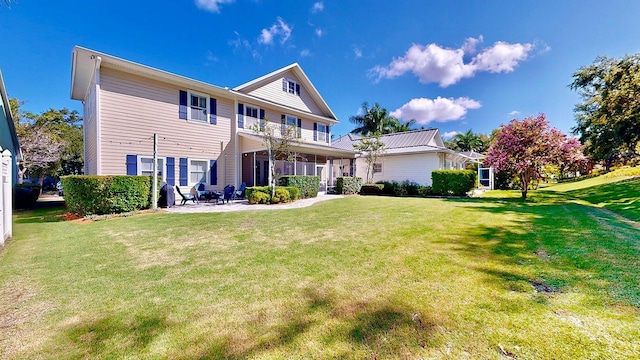 rear view of property with a lawn