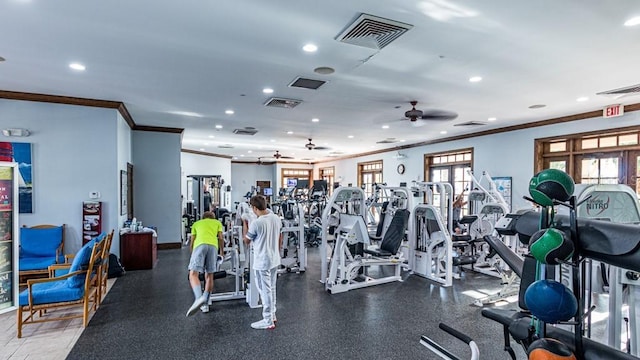 workout area featuring ornamental molding, visible vents, and a ceiling fan