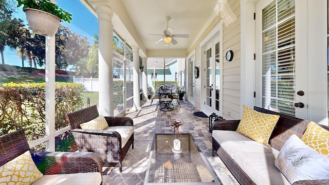 sunroom / solarium featuring a ceiling fan