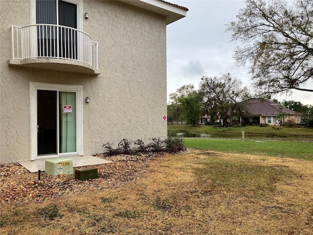 view of home's exterior featuring a lawn and stucco siding