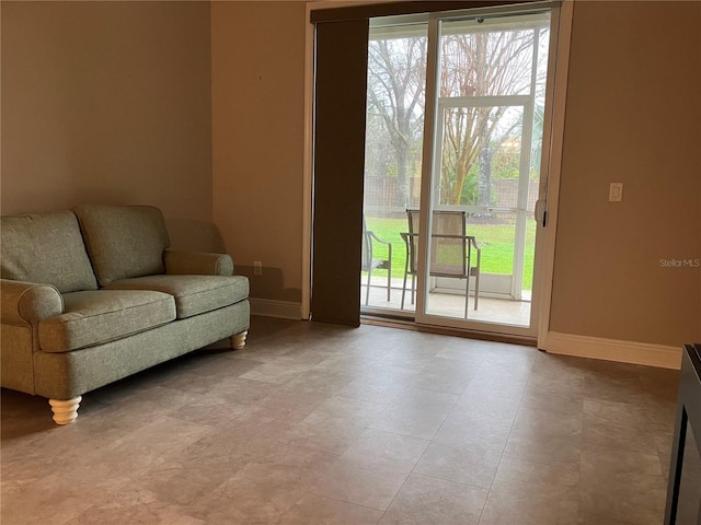 living area with baseboards and a wealth of natural light