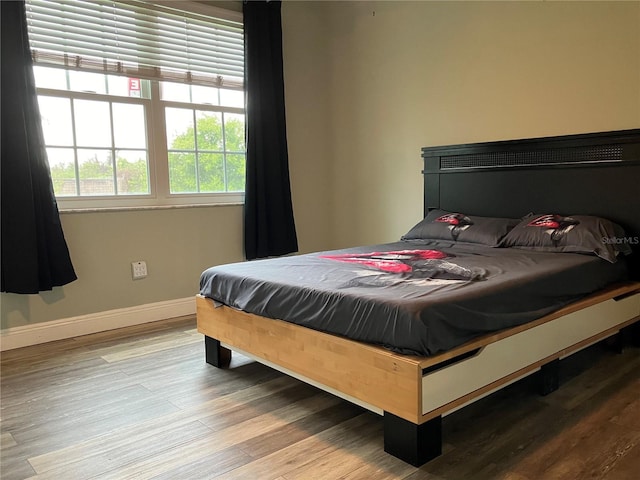 bedroom featuring light wood-type flooring and baseboards