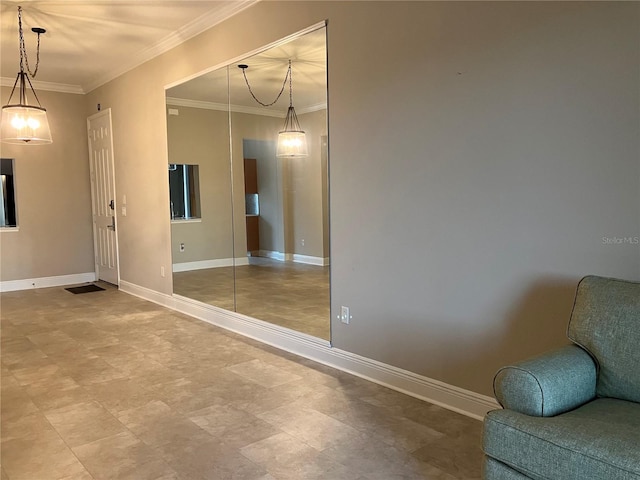 spare room with ornamental molding and baseboards