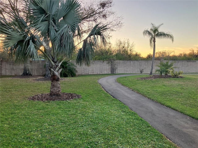 view of home's community featuring a yard and fence