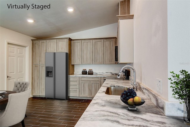 kitchen featuring light brown cabinets, a sink, light countertops, stainless steel refrigerator with ice dispenser, and wood tiled floor