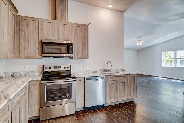 kitchen featuring light brown cabinets, appliances with stainless steel finishes, dark wood-style flooring, and a sink